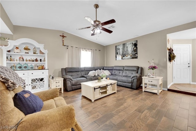 living room with ceiling fan, lofted ceiling, and hardwood / wood-style floors