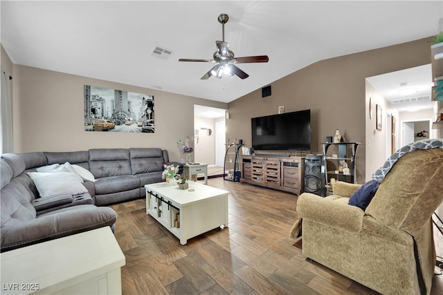 living room with ceiling fan, lofted ceiling, and dark hardwood / wood-style floors