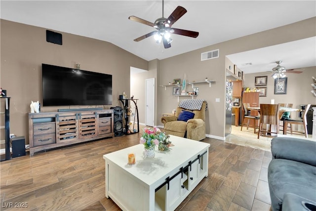 living room featuring ceiling fan, lofted ceiling, and wood-type flooring