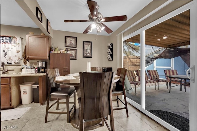 dining space featuring ceiling fan and light tile patterned floors