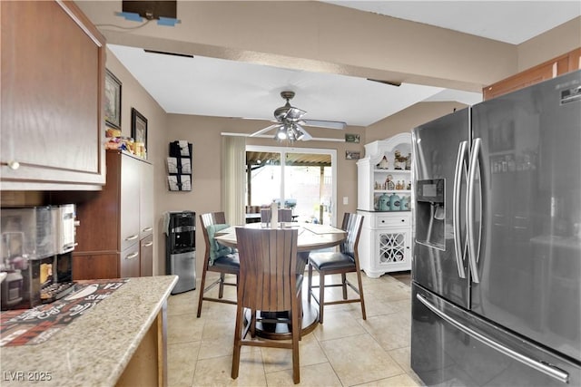 dining area featuring light tile patterned floors and ceiling fan