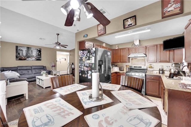 dining area with ceiling fan, sink, and dark parquet floors