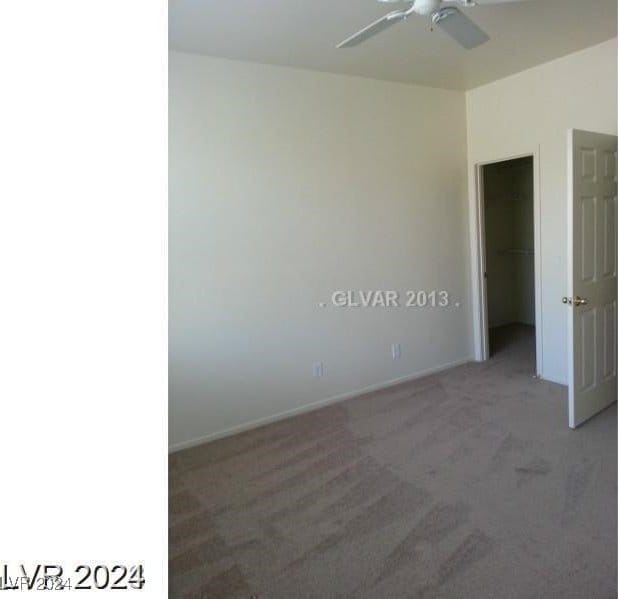 spare room featuring carpet flooring and ceiling fan