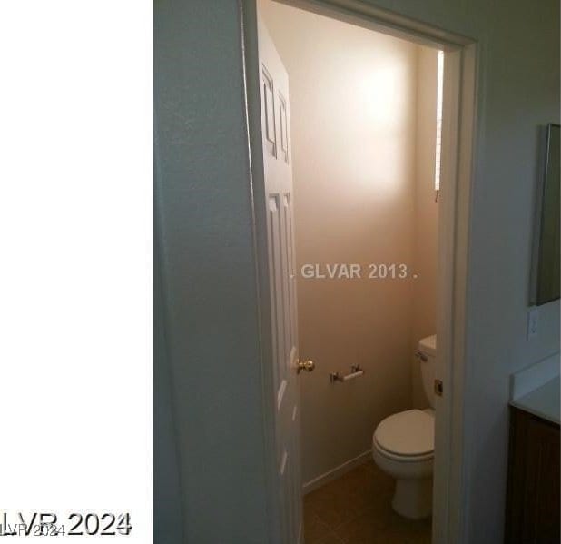 bathroom featuring vanity, toilet, and tile patterned floors