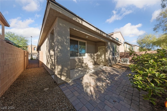 view of side of home with a patio