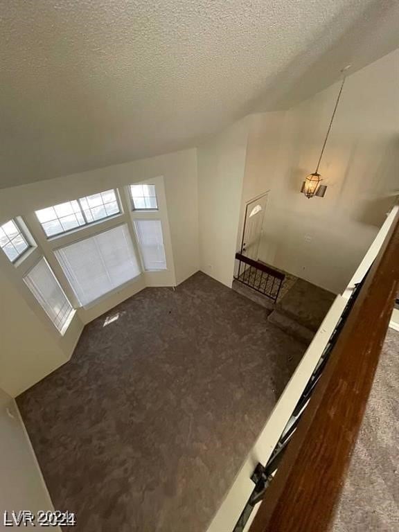 interior space featuring a textured ceiling and carpet