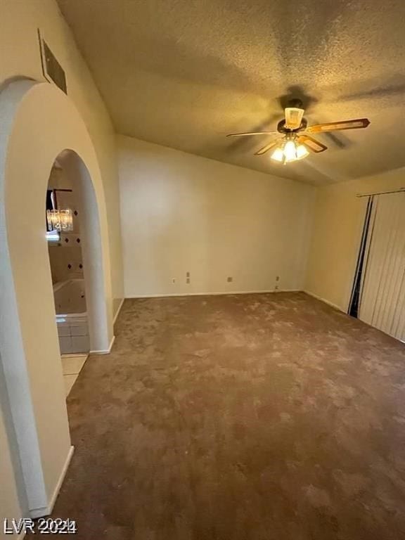 spare room featuring a textured ceiling, carpet, and ceiling fan