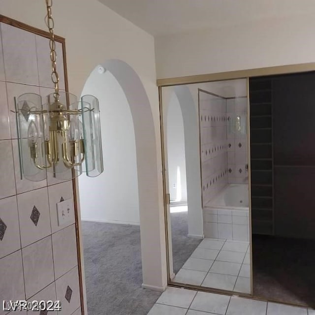 bathroom featuring plus walk in shower and tile patterned floors