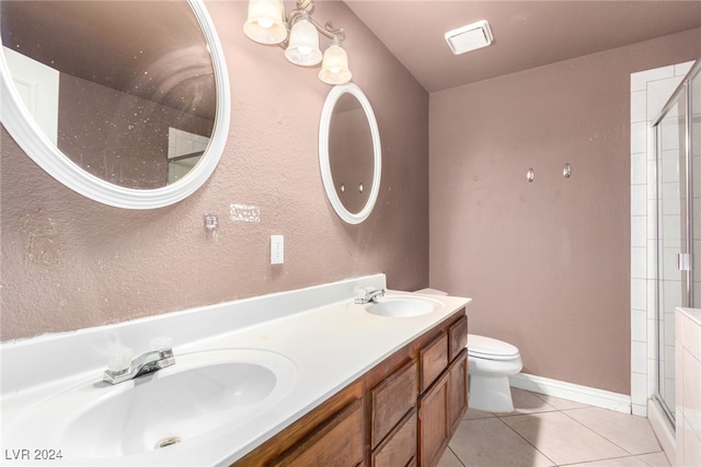 bathroom with tile patterned floors, vanity, toilet, and an enclosed shower