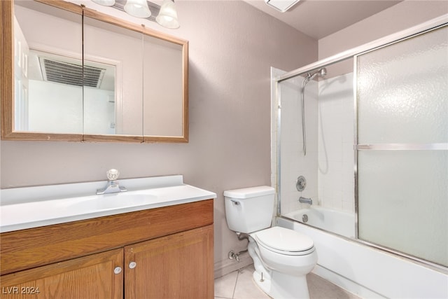 full bathroom featuring tile patterned floors, vanity, toilet, and bath / shower combo with glass door