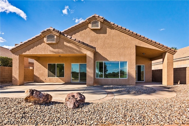 back of property with a patio