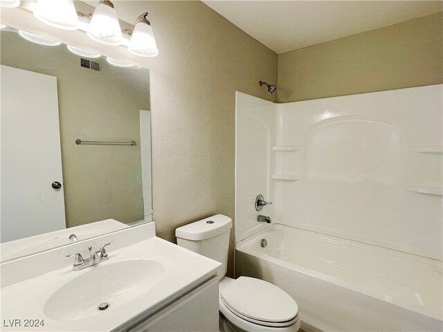 full bathroom featuring  shower combination, vanity, and toilet