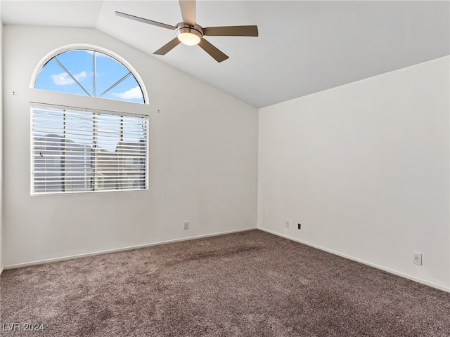 carpeted empty room with vaulted ceiling and ceiling fan