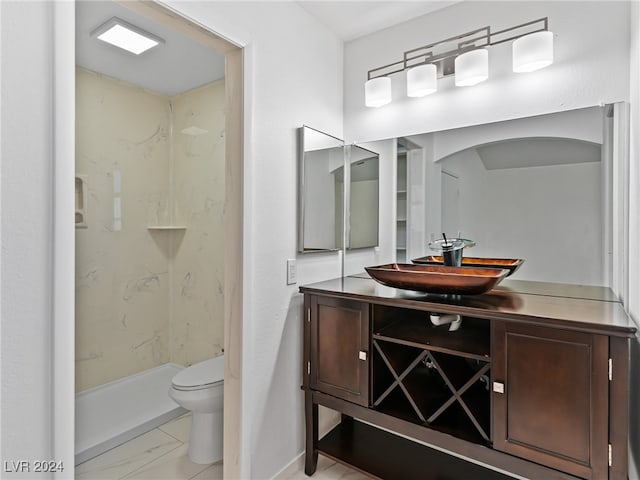 bathroom featuring vanity, toilet, and walk in shower