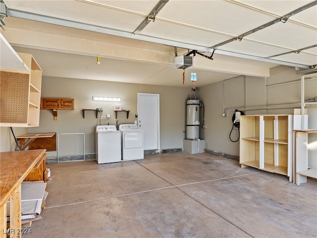 garage featuring washer and dryer, strapped water heater, and a garage door opener