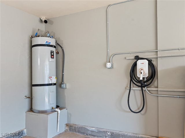 utility room featuring water heater