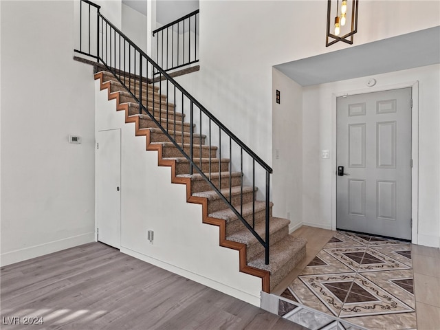 foyer featuring a towering ceiling and hardwood / wood-style flooring