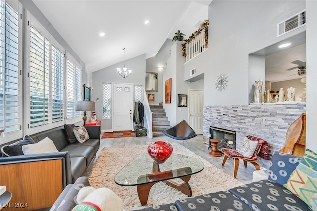 living room featuring a fireplace, high vaulted ceiling, and ceiling fan with notable chandelier