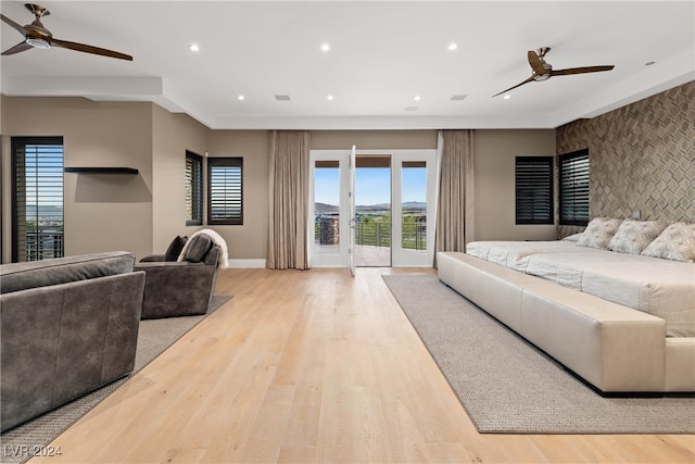 bedroom with access to exterior, light hardwood / wood-style flooring, and ceiling fan