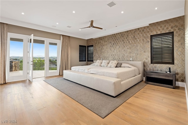 bedroom with access to outside, light hardwood / wood-style flooring, and ceiling fan