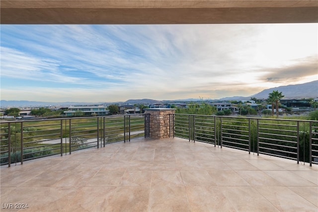 view of patio featuring a mountain view and a balcony