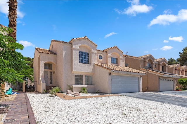 mediterranean / spanish-style house featuring a garage