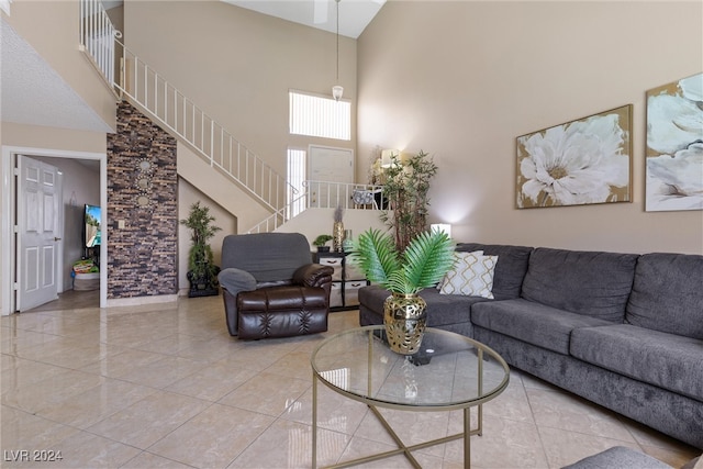 living room featuring a towering ceiling and tile patterned flooring