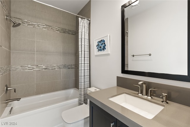 full bathroom with vanity, shower / bath combination with curtain, and toilet