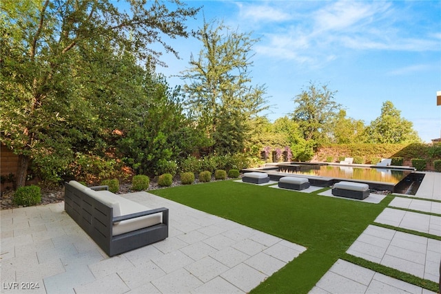 view of community with a patio and a lawn