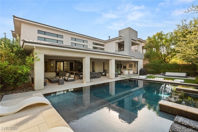 back of house featuring a patio area and an outdoor hangout area