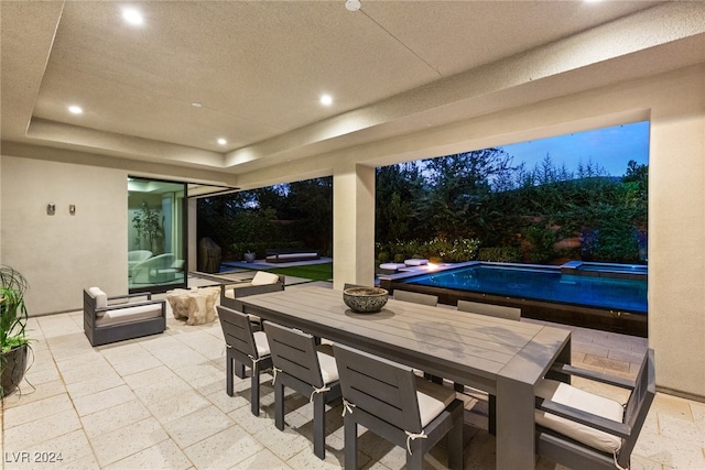 view of patio / terrace featuring a pool with hot tub