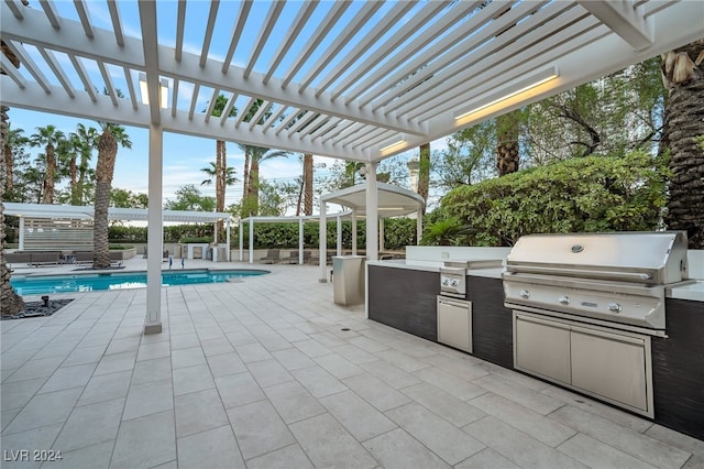 view of patio / terrace featuring a pergola, area for grilling, and exterior kitchen