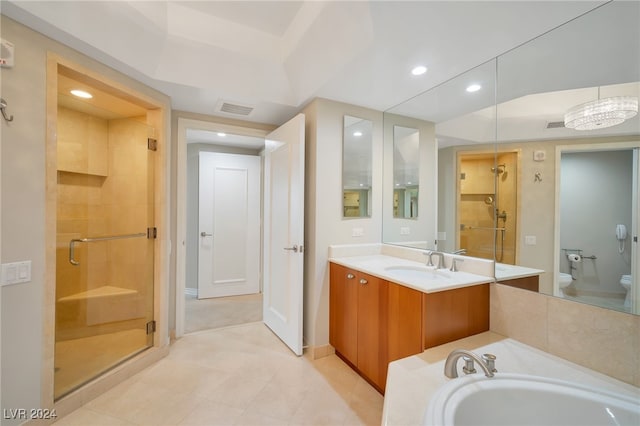 full bathroom featuring tile patterned flooring, a chandelier, toilet, vanity, and independent shower and bath