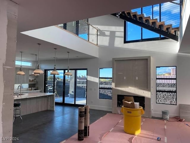 living room featuring a high ceiling and sink