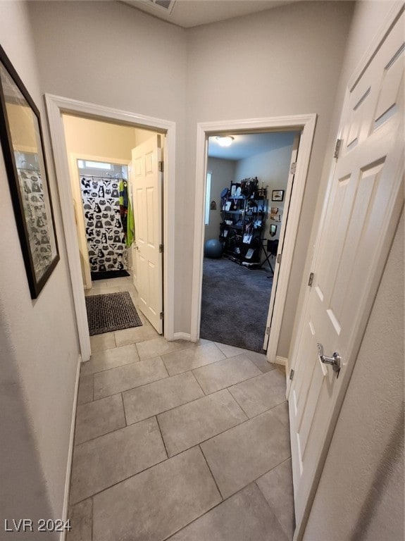 hallway with light tile patterned floors