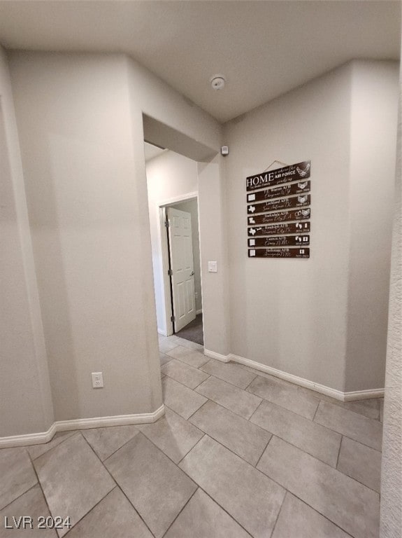 hall with light tile patterned flooring