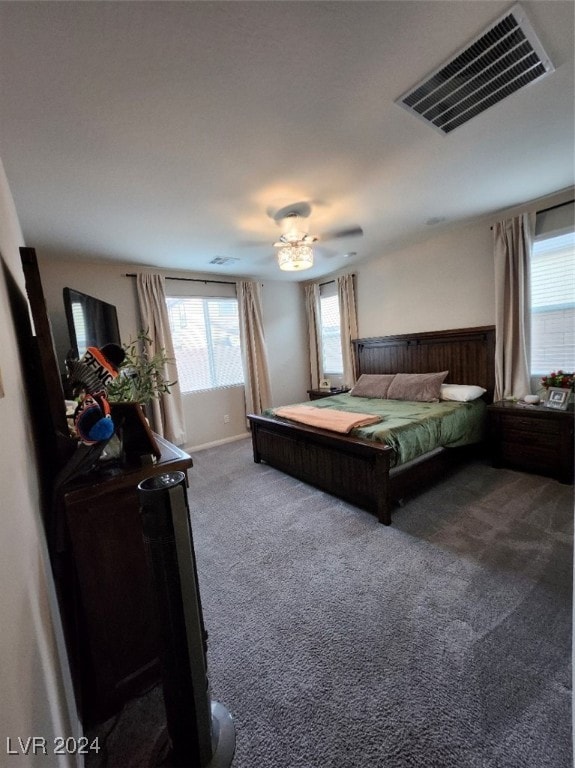 bedroom featuring multiple windows, carpet flooring, and ceiling fan