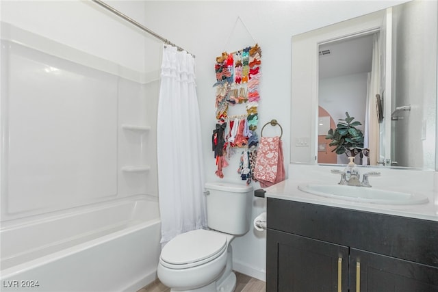 full bathroom with hardwood / wood-style flooring, vanity, shower / bath combination with curtain, and toilet