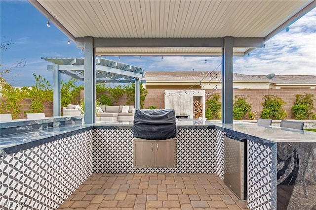 view of patio with a pergola, an outdoor bar, and a grill