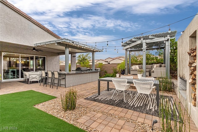 view of patio / terrace featuring an outdoor living space, ceiling fan, a pergola, and an outdoor kitchen