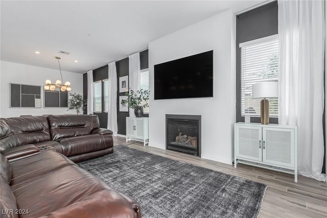 living room featuring hardwood / wood-style floors and an inviting chandelier