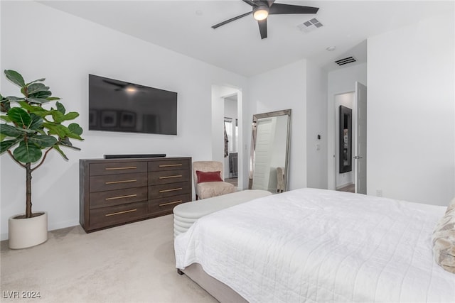 carpeted bedroom featuring ensuite bathroom and ceiling fan