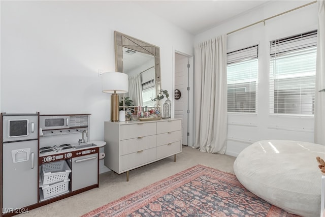 living area featuring light carpet