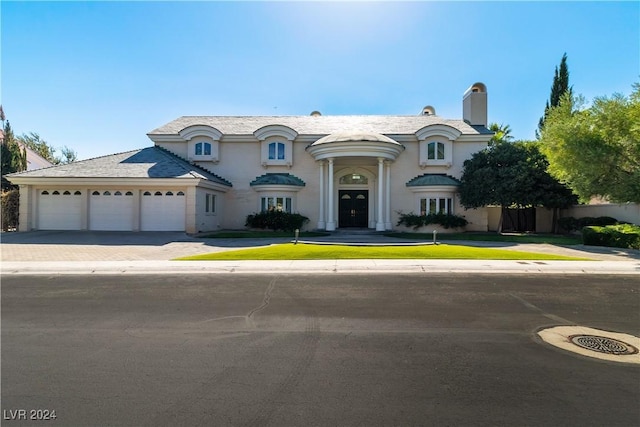 french country style house featuring a garage