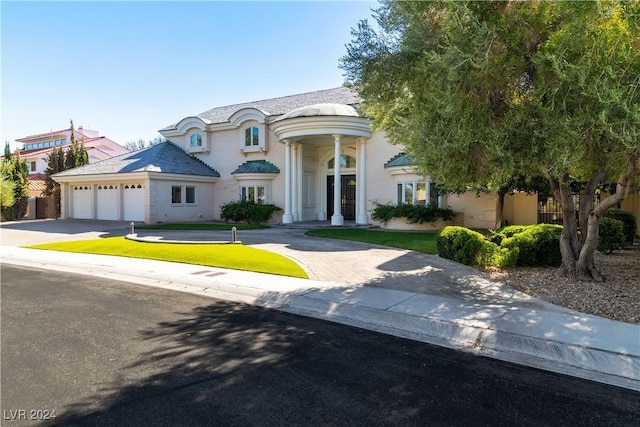 view of front of home with a garage and a front lawn