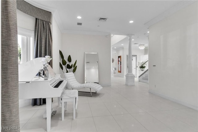 living room with decorative columns, crown molding, and light tile patterned flooring