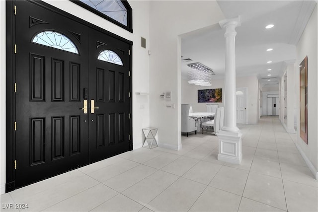 foyer with light tile patterned floors and a towering ceiling