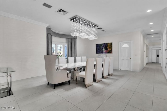 tiled dining room featuring a chandelier and ornamental molding