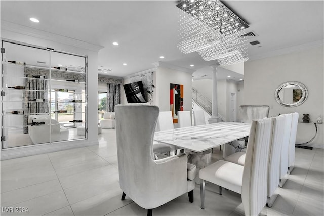 dining space featuring light tile patterned floors, ornamental molding, and an inviting chandelier