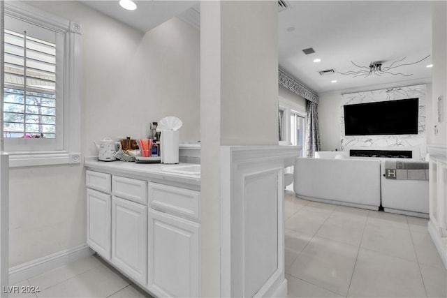 kitchen featuring plenty of natural light, white cabinets, and light tile patterned flooring